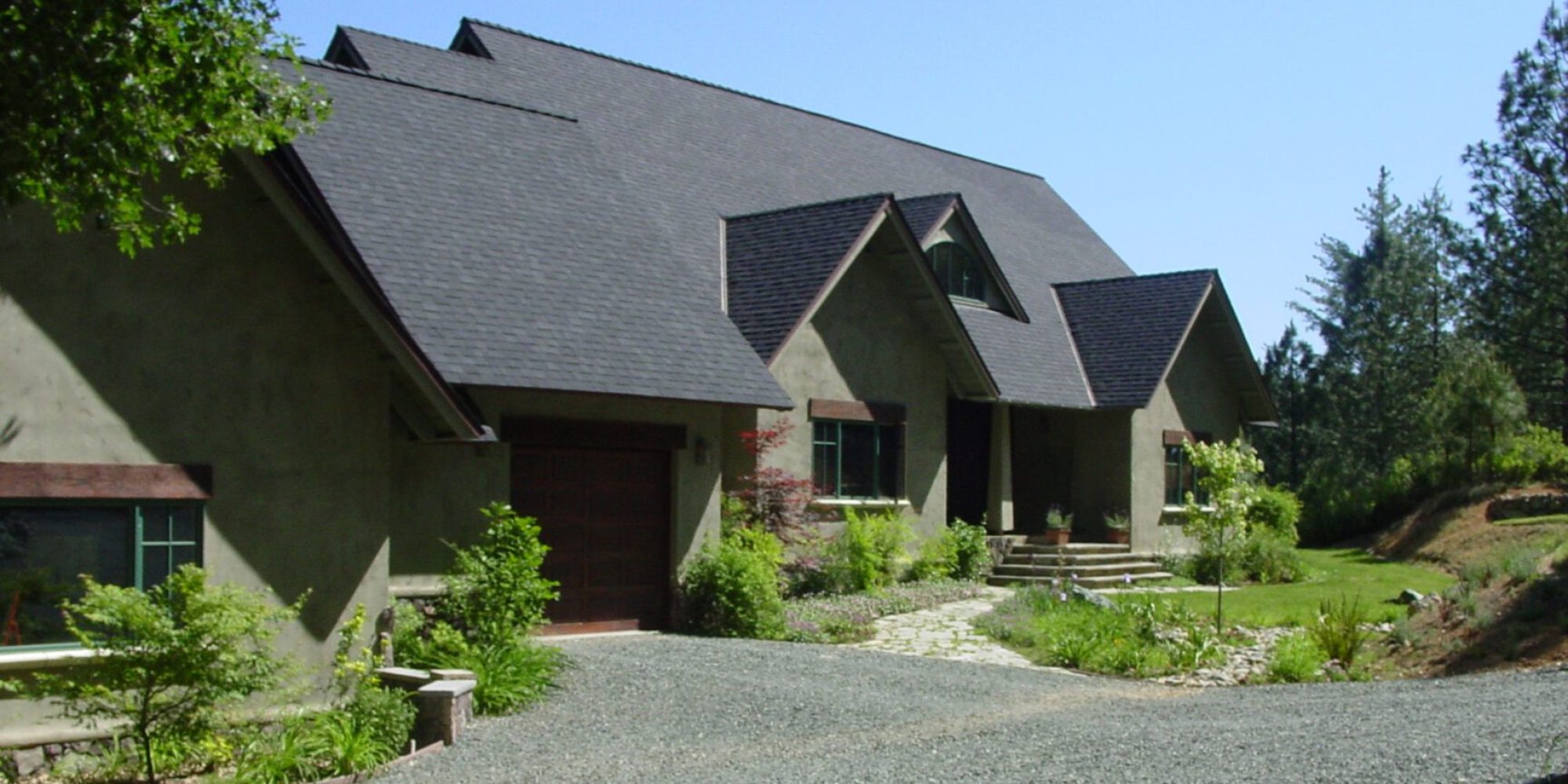 A large house with a driveway and trees