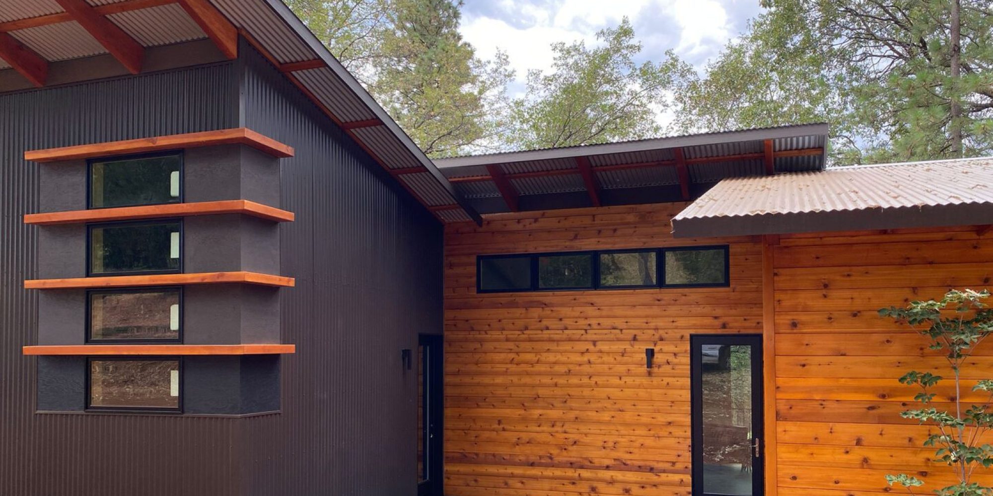 A house with wood siding and a large garage door.